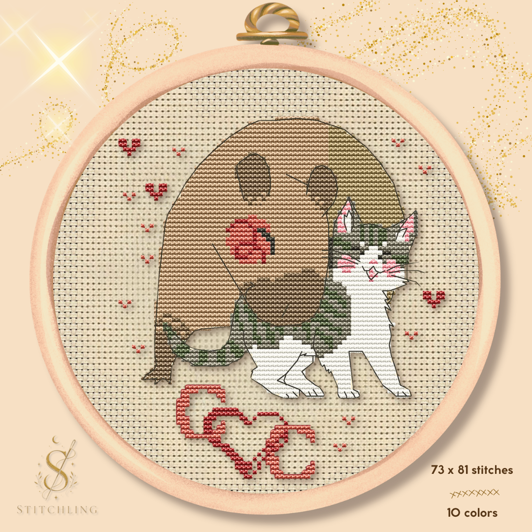 Cat and Capybara Friends cross stitch pattern featuring a smiling cat cuddling a gentle capybara, cute friendship embroidery design with hearts in a wooden hoop, beginner-friendly PDF pattern by Stitchling.