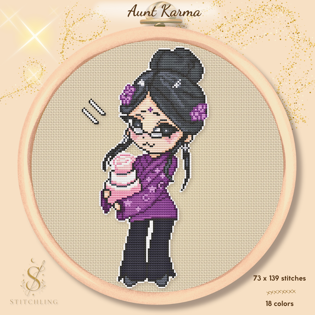 Preview of the Aunt Karma cross stitch pattern in an embroidery hoop, featuring a chibi witch with dark hair, glasses, a purple outfit, and a pink birthday cake on a warm beige fabric background.