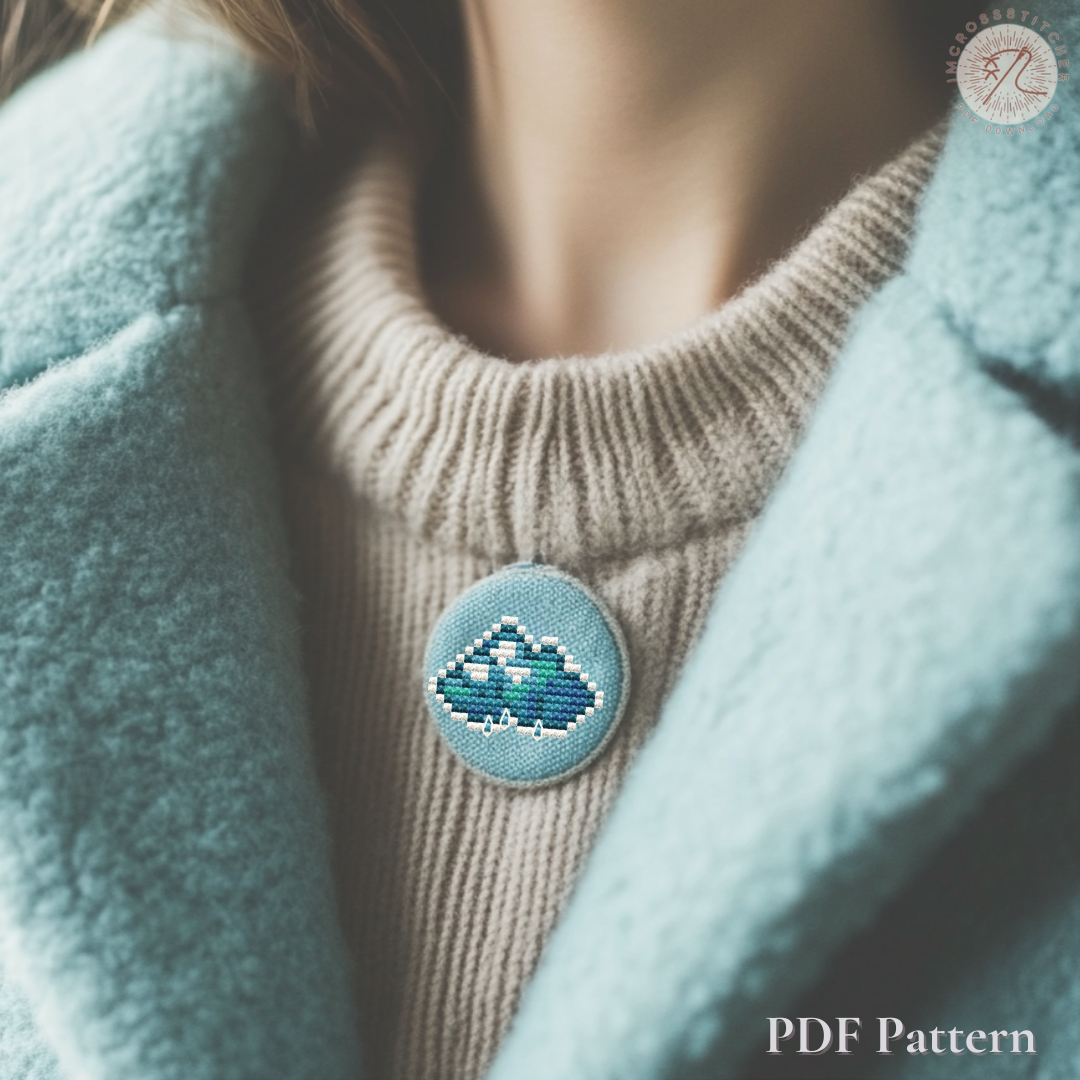 Handmade cloud pendant stitched from a mini cross stitch pattern included in the Lumi Mini Set collection.
