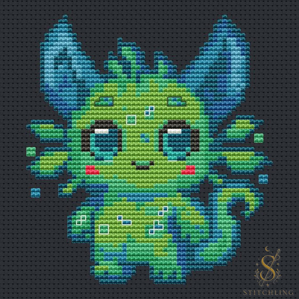 Finished Lumi the Glowing Beast cross stitch artwork displayed as fantasy embroidery wall decor