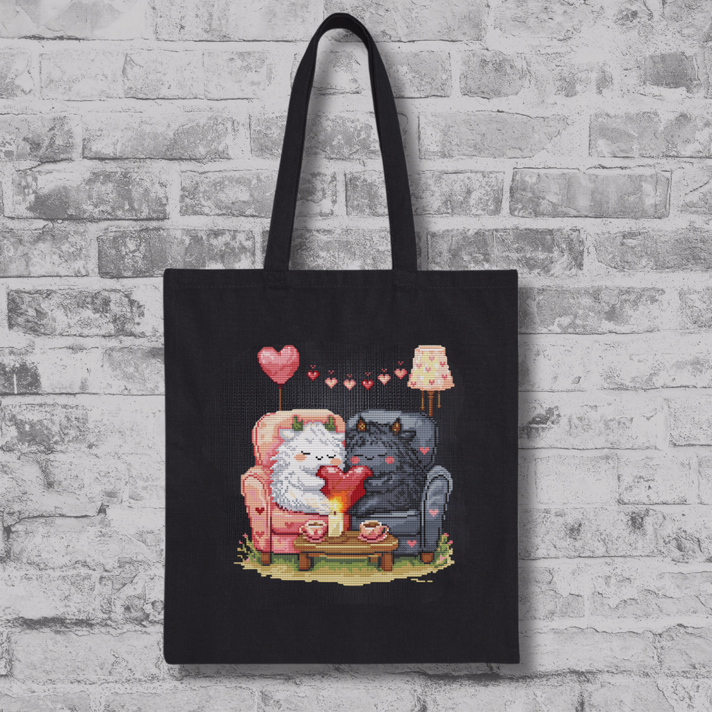 Black tote bag featuring the Romantic Beasties Love Duo cross stitch design, fantasy creature embroidery and handmade gift inspiration