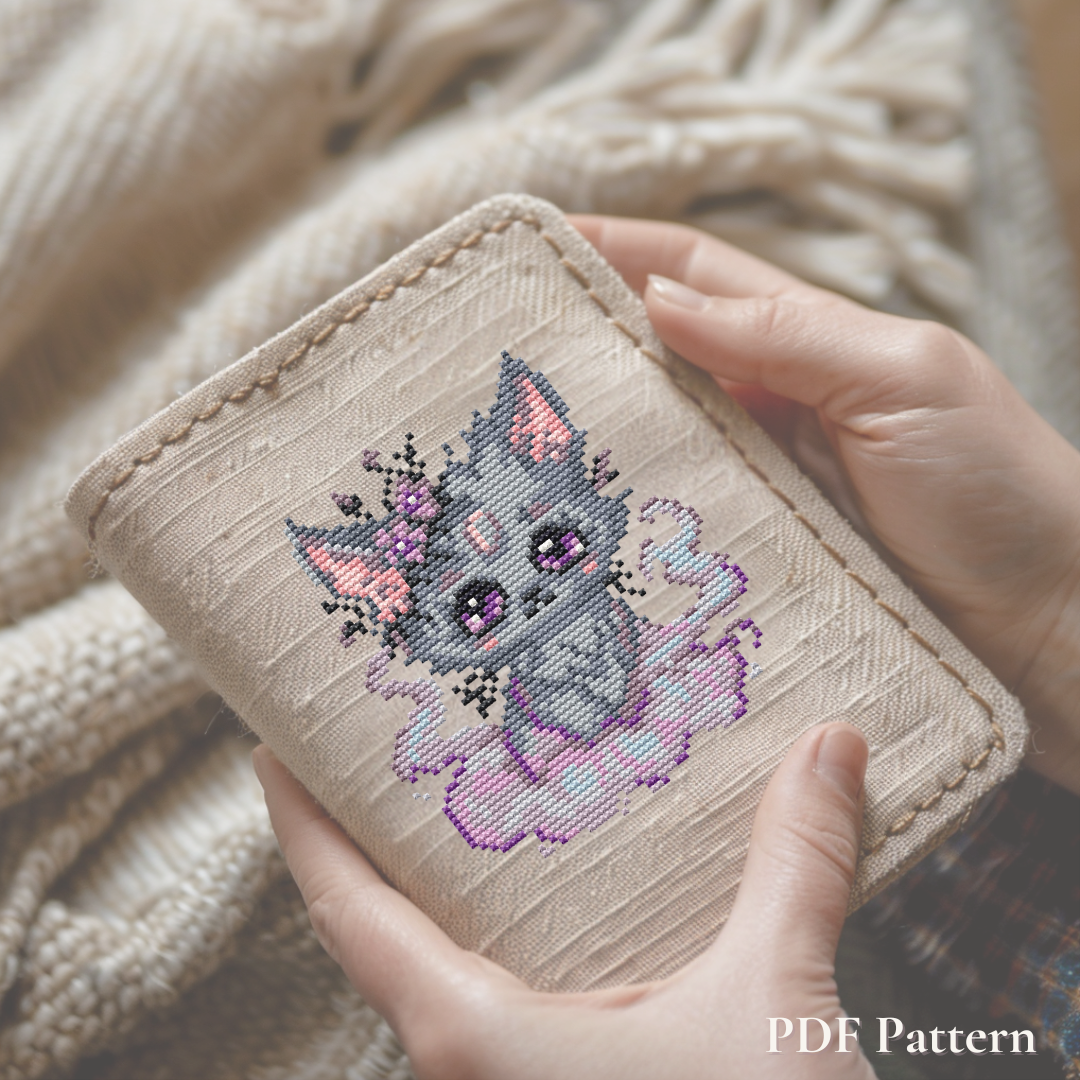 Misty Beastie cross stitch pattern stitched on a handmade fabric notebook cover, dreamy fantasy creature embroidery project and cozy gift idea.