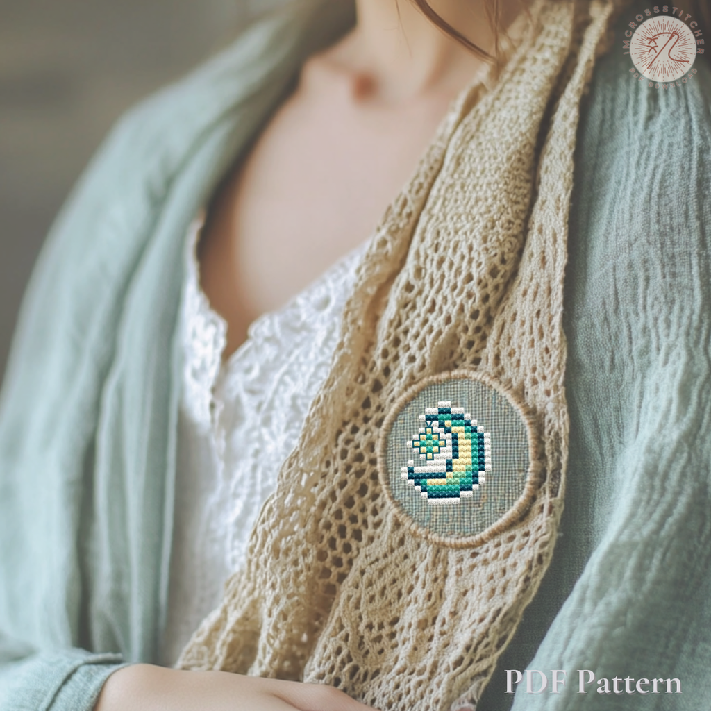 Moon and star embroidered pendant created with a mini cross stitch pattern from the Lumi Mini Set.