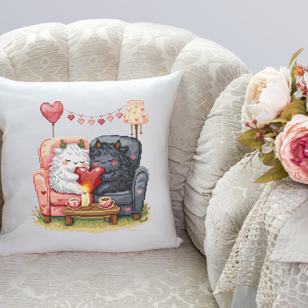 Decorative pillow featuring the Romantic Beasties Love Duo cross stitch design, cute fantasy couple embroidery and gift idea for couples
